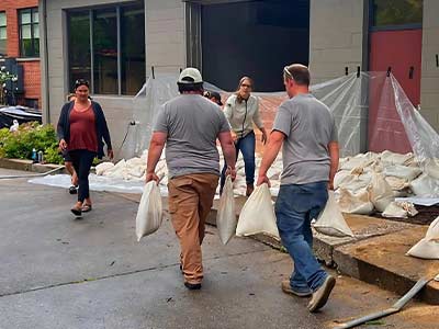 Placing sand bags after significant flooding in Northfield